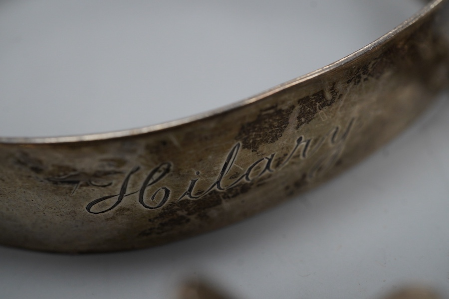 A collection of silver jewels, comprising: a bangle; a chain necklace suspending two winding toothpicks, one with toothpick deficient; a rope twist chain; a pair of cufflinks with the initials DBH; a pendant of abstract